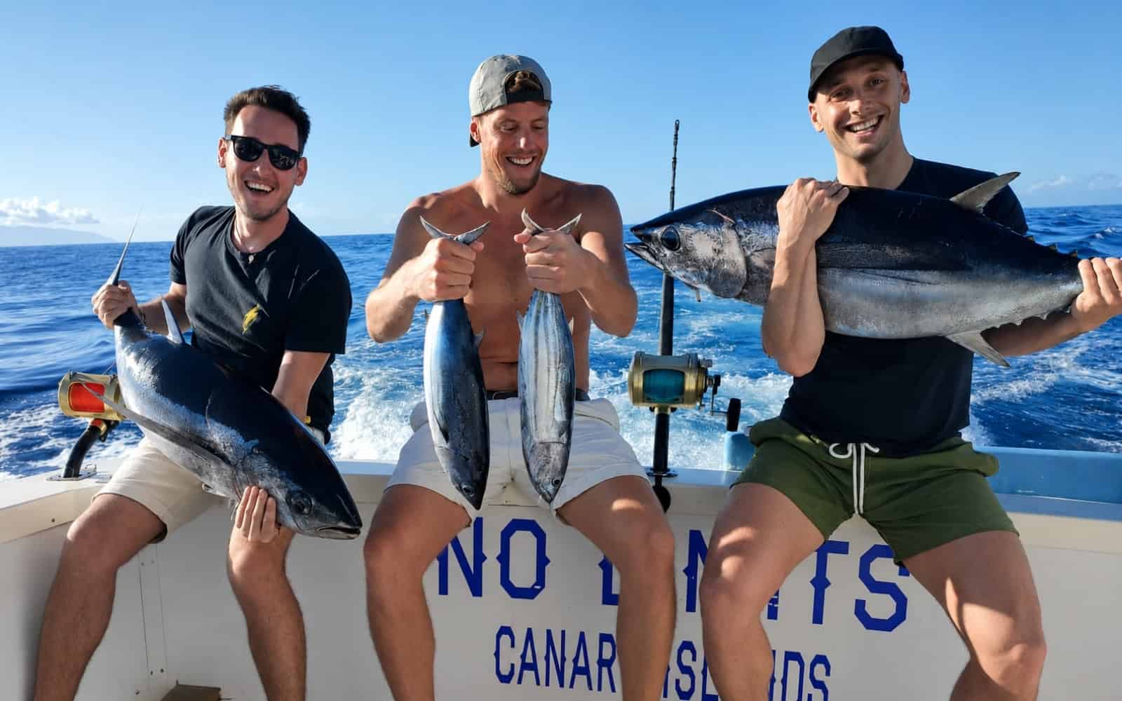 Guests holding fresh tuna on a fishing boat in Tenerife