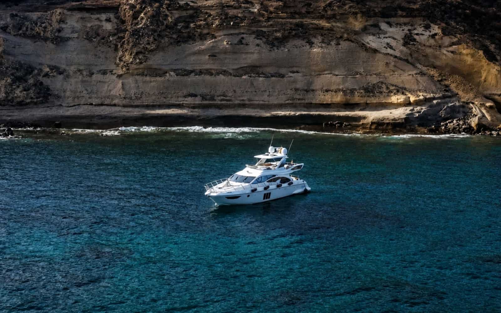 Aerial view of a private yacht along the volcanic coast of Tenerife