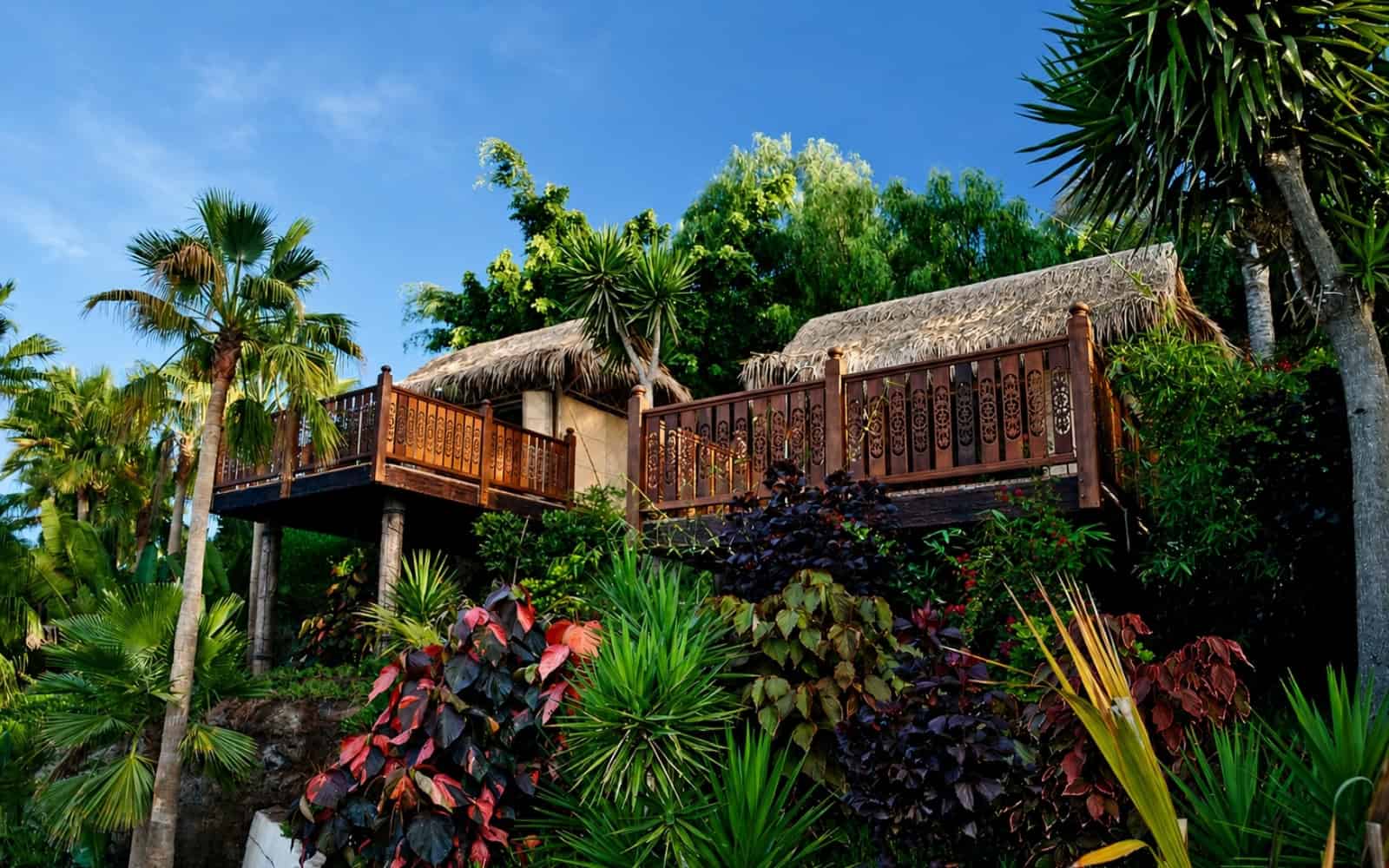 Tropical cabana with a wooden balcony surrounded by gardens at Siam Park in Tenerife