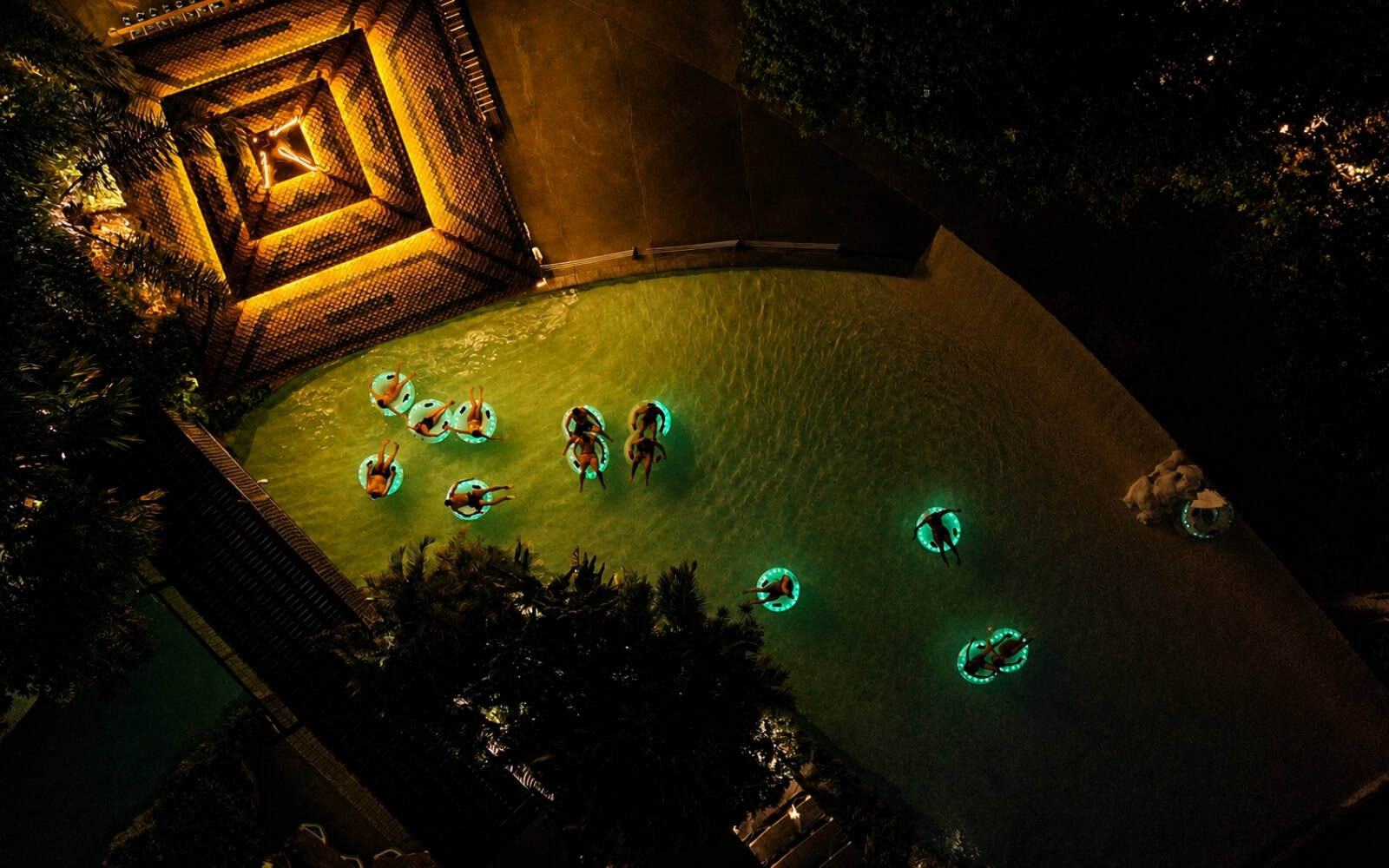 Guests floating through the lit lazy river at Siam Park Night in Tenerife