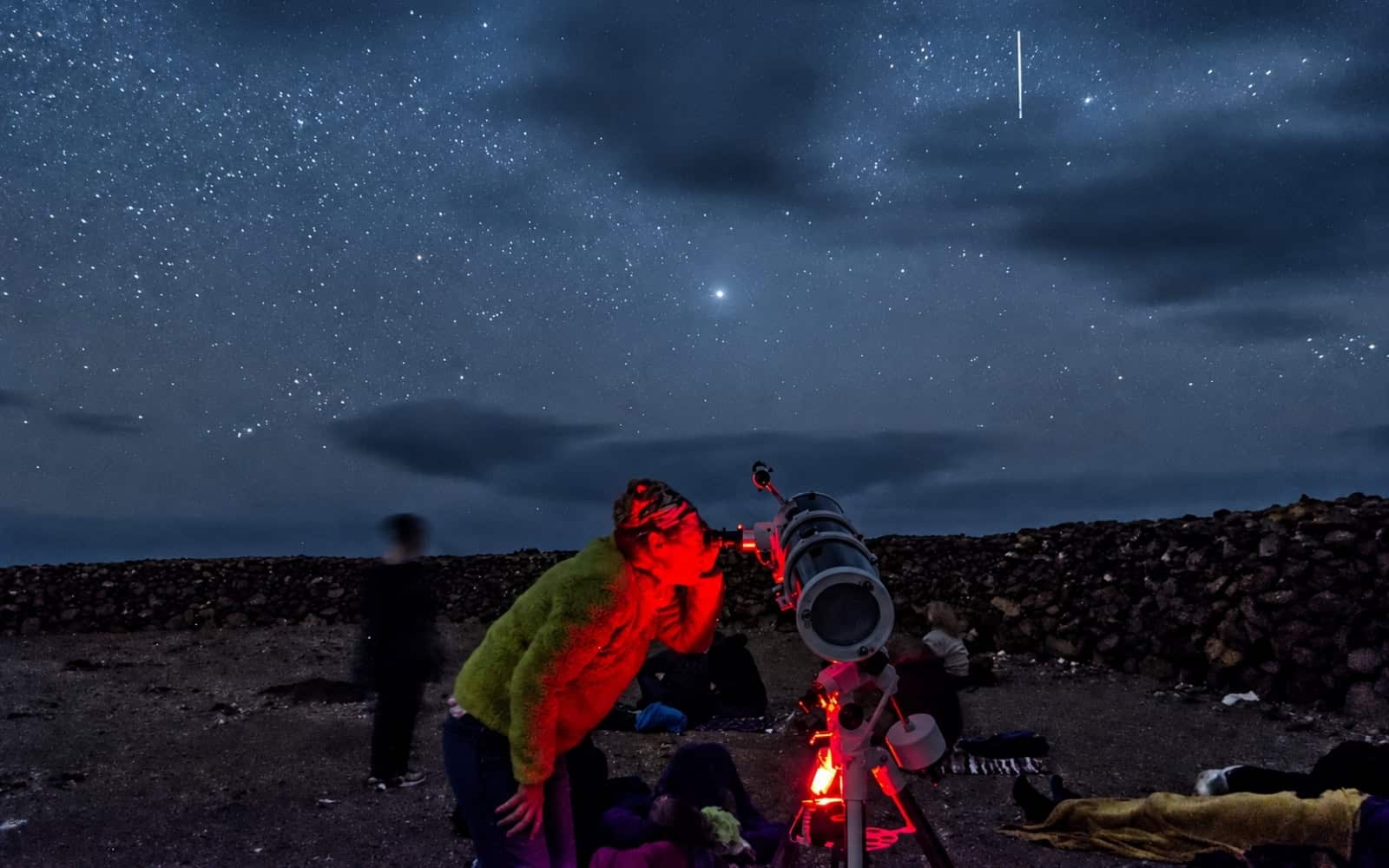 Guests using a telescope under the night sky in Fuerteventura