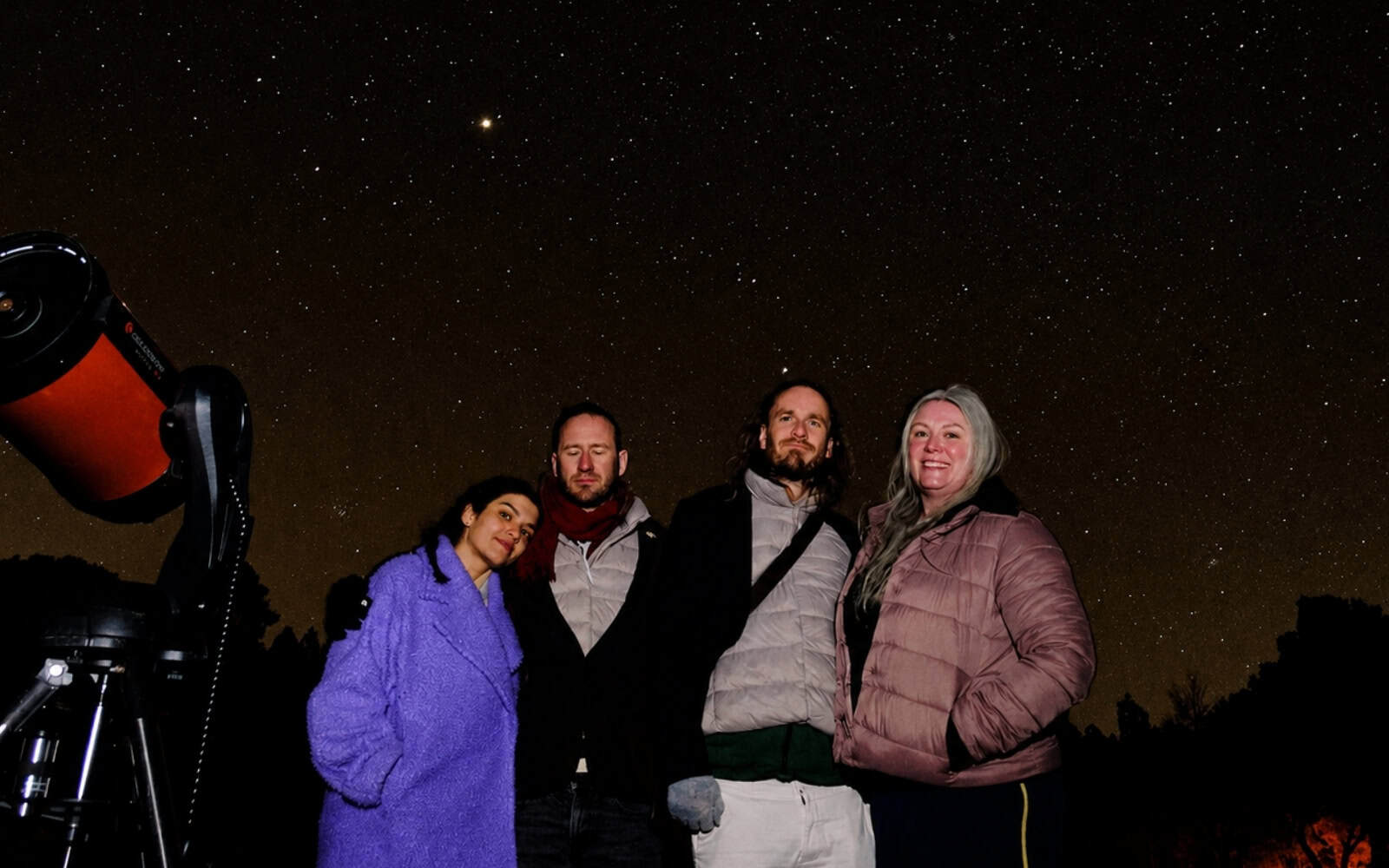 Guests beside a telescope under a starry sky in Gran Canaria