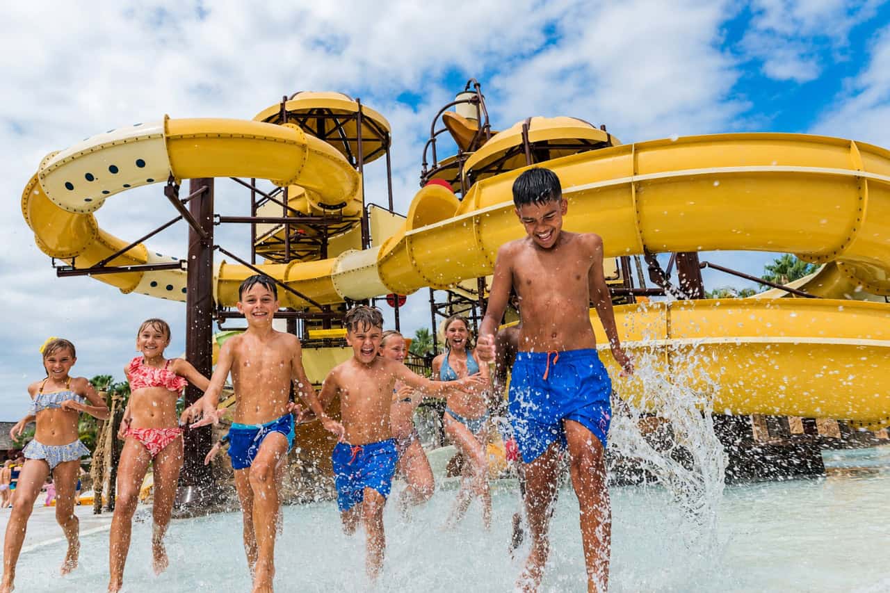 Children in the splash area with yellow slides at Aqualand