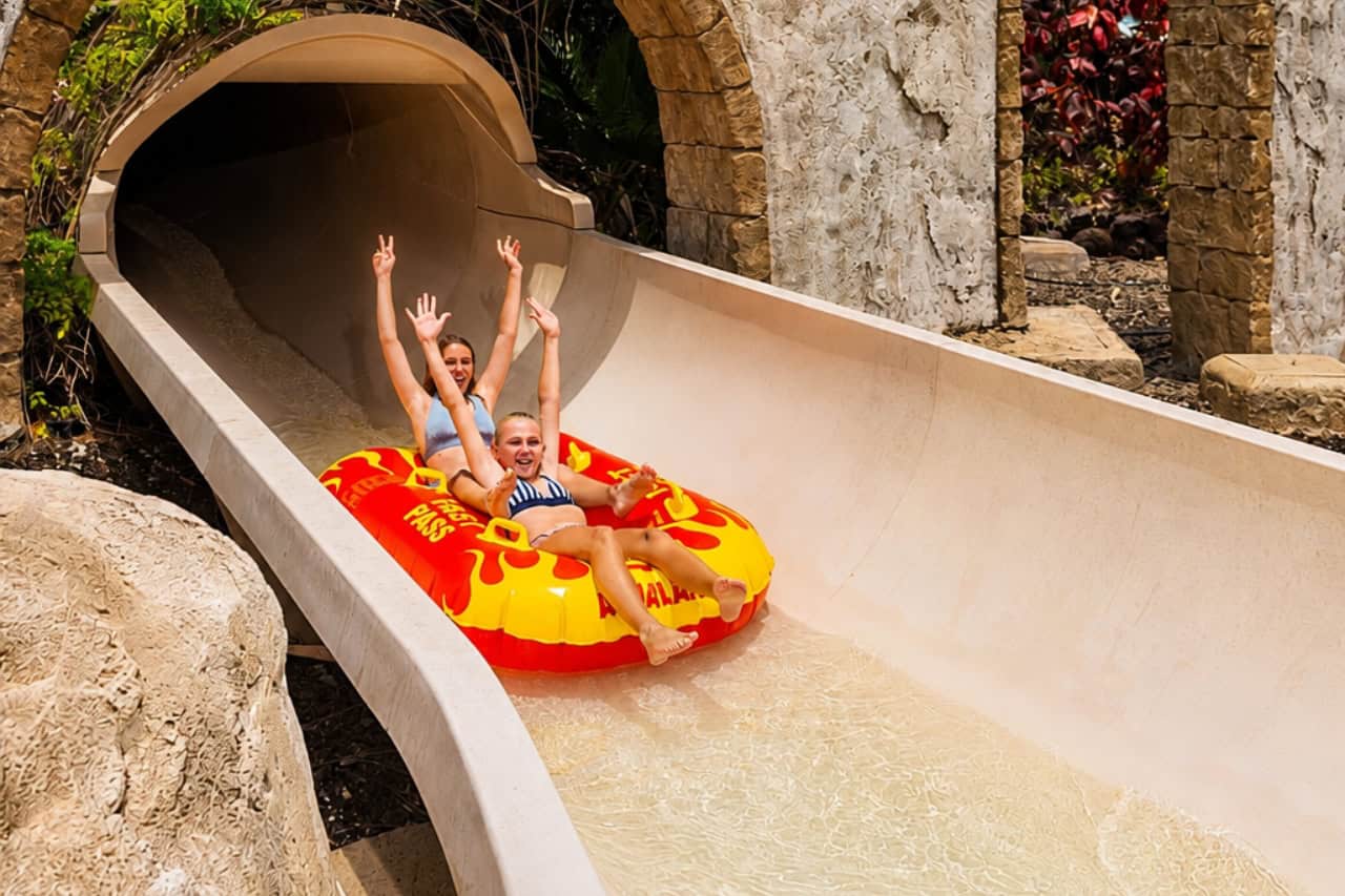 Two guests on a red tube slide at Aqualand