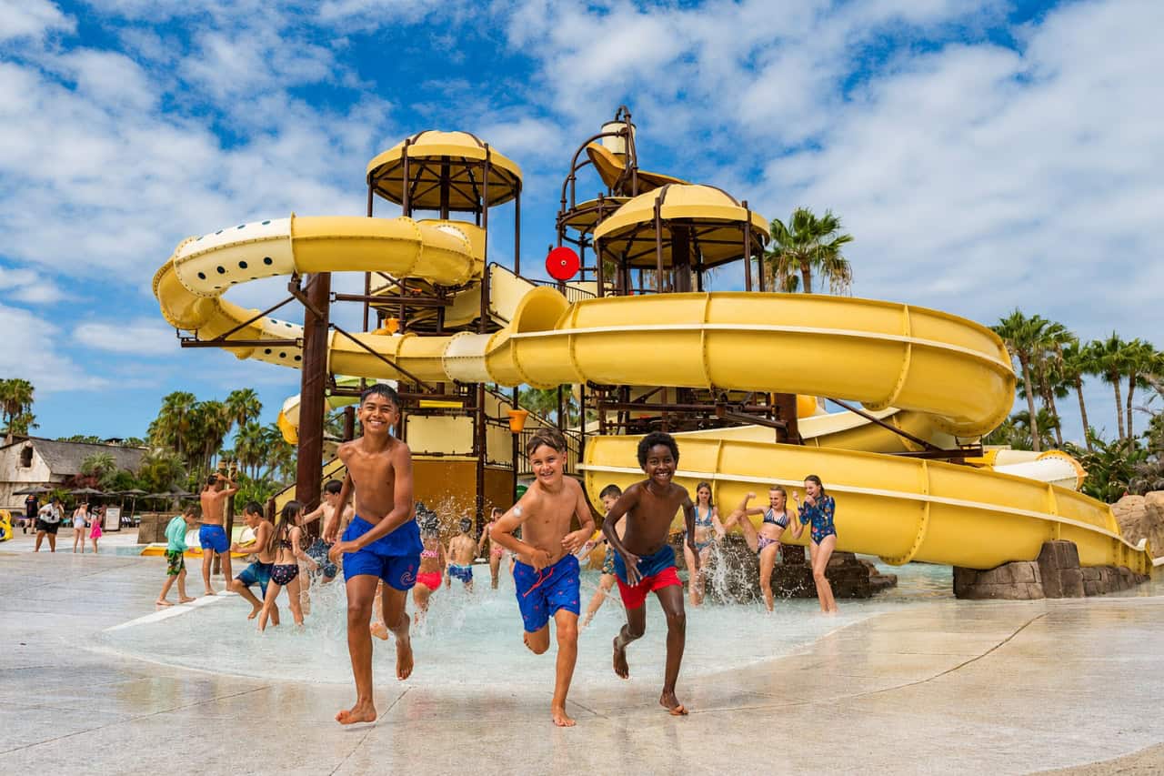 Children running through the splash area at Aqualand Tenerife