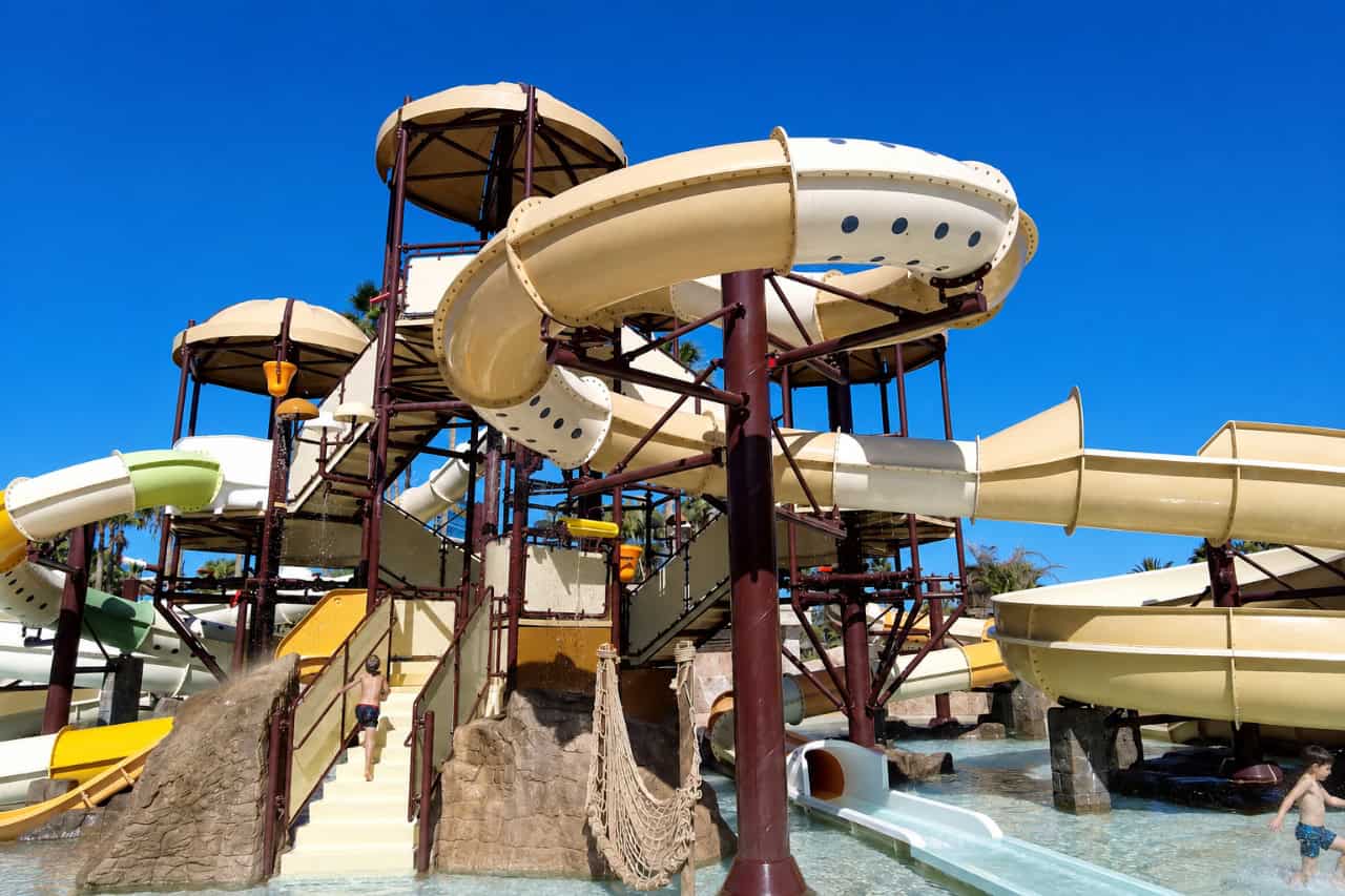 Yellow slide tower with tube slides at Aqualand Tenerife