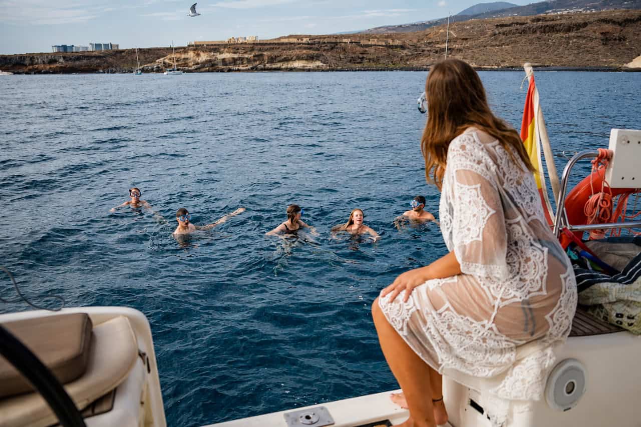 Guests swimming and snorkelling beside the Atlantic Star during a small-group boat trip and whale-watching tour from Puerto Colón.