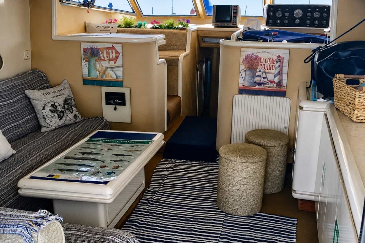 Comfortable interior lounge and helm area of the Blue M private yacht in Gran Canaria, with seating, navigation controls and nautical décor.