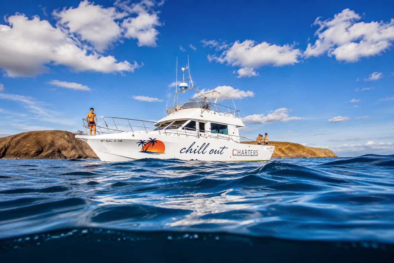 Chill Out Cruise private boat charter sailing along the Lanzarote coast near Playa Blanca.