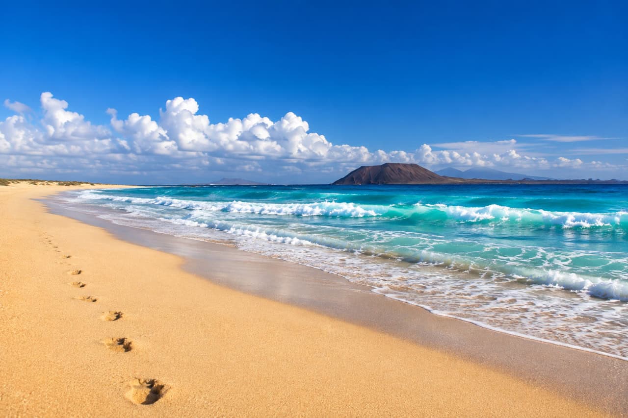 Turquoise water and golden sand at Corralejo beach Fuerteventura
