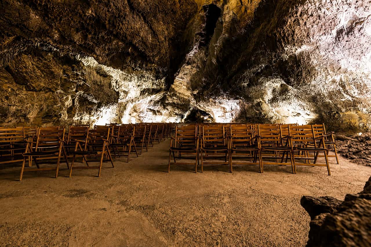 Rows of chairs inside the natural concert hall at Cueva de los Verdes in Lanzarote, a unique volcanic lava tube open to visitors during a Cueva de los Verdes tour.
