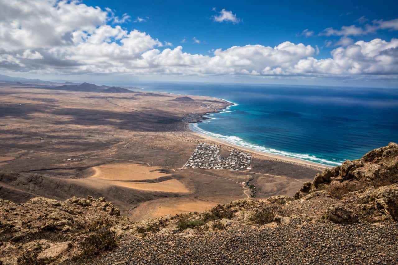 View from Mirador del Río overlooking Famara coastline in Lanzarote, a popular stop to combine with a Visit Cueva de los Verdes and Jameos del Agua tour.