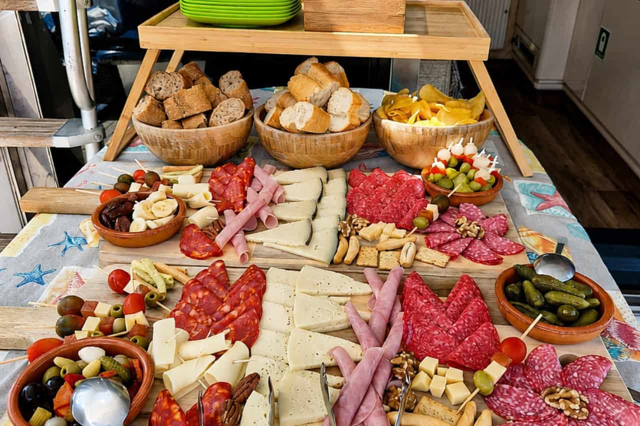 Onboard buffet with cold meats, cheeses, bread and olives during a boat trip in Gran Canaria
