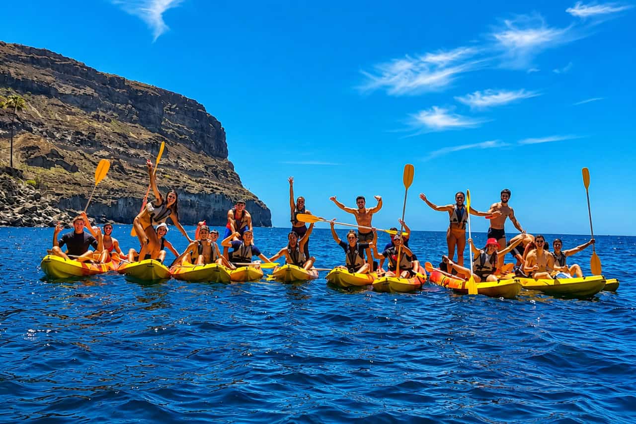 Group of kayakers enjoying a guided sea kayaking adventure along the volcanic coast of Gran Canaria.