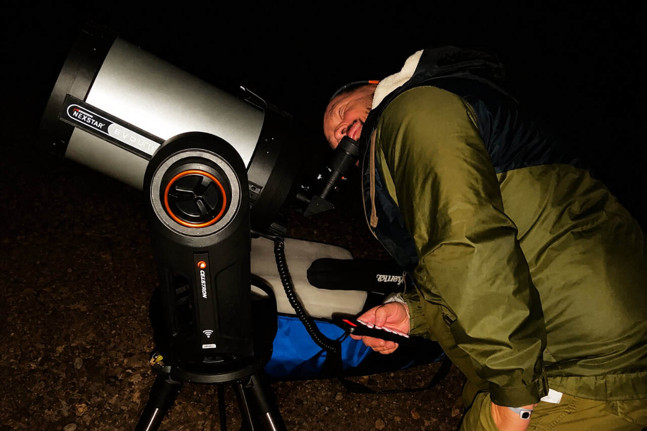 Guest looking through a Celestron telescope during a guided Mount Teide stargazing tour beneath Tenerife’s dark night sky.