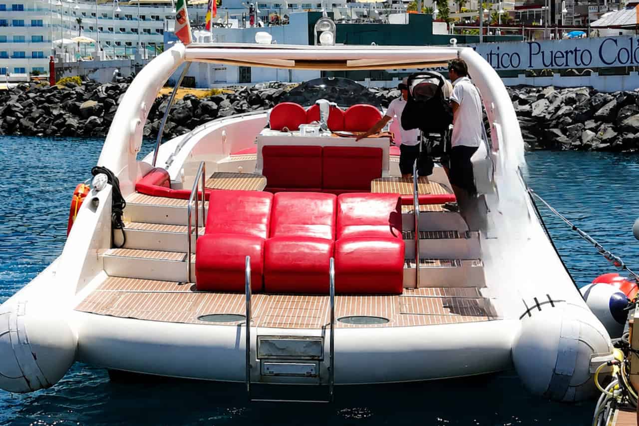 Opera 60 private charter boat in Puerto Colón with red sun beds and crew preparing the trip.