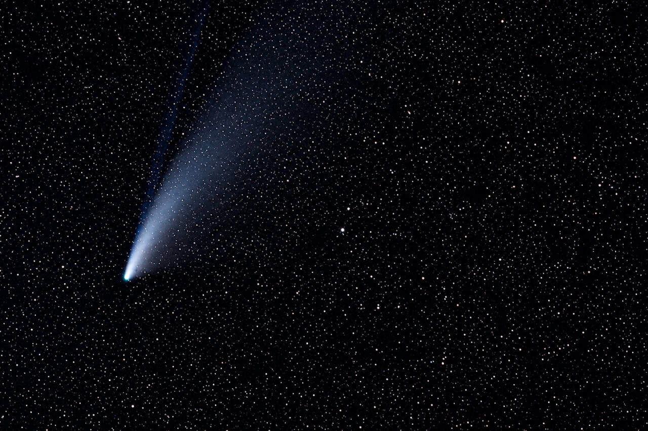 Comet crossing the star-filled sky during a Teide stargazing tour from Puerto de la Cruz
