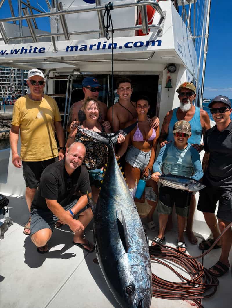 Shared fishing trip in Gran Canaria with guests and crew celebrating a large tuna catch on board