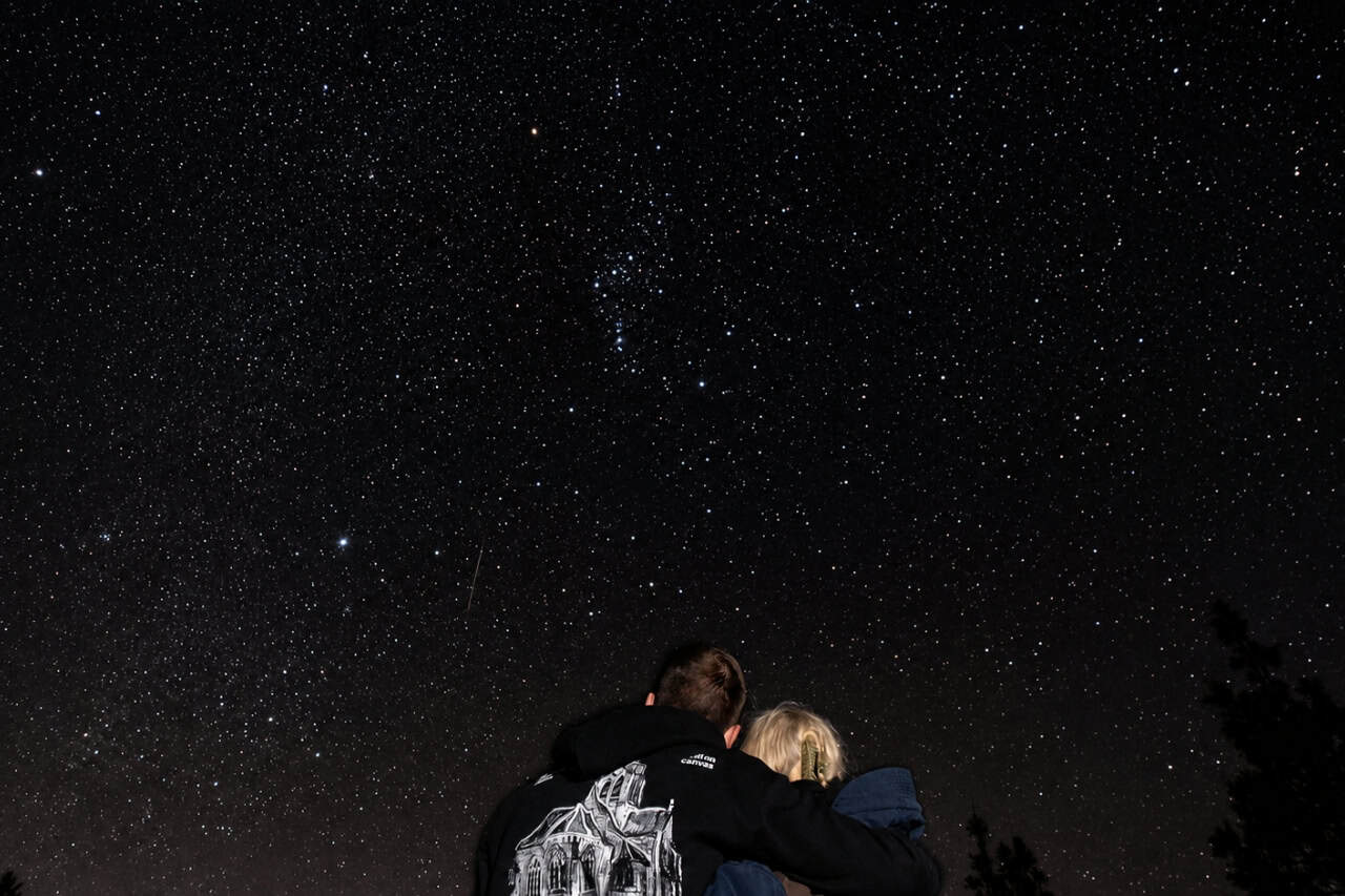 Couple looking up at a star filled sky in Teide National Park