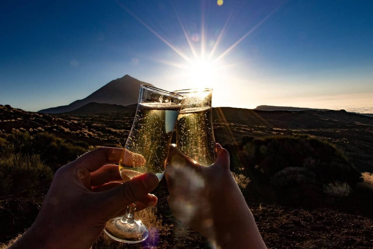 Guests raising glasses at sunset with Mount Teide in the background during the Teide by Night tour.