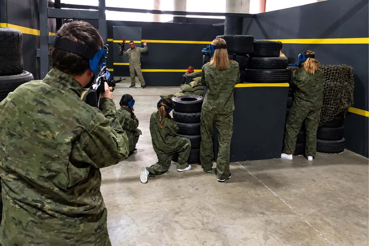 Players moving between barriers during an indoor airsoft game in Las Chafiras