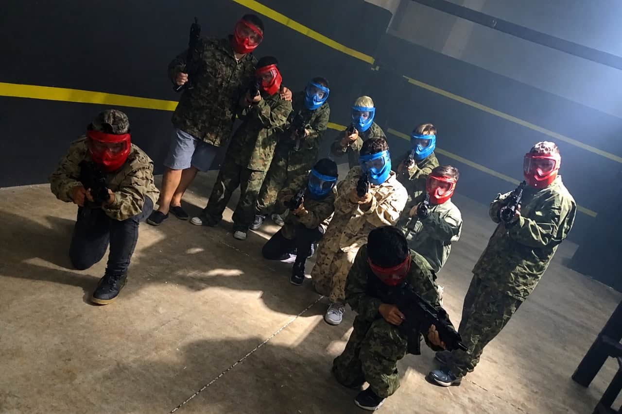 Group of players in masks and camouflage before an indoor airsoft game in Tenerife