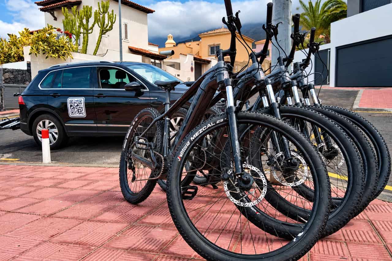 Mountain bikes lined up beside the delivery vehicle in Tenerife