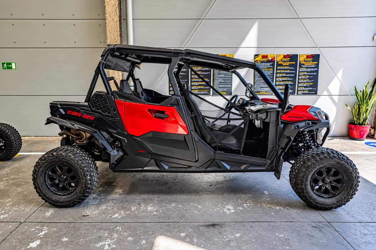 Red and black Can-Am Maverick buggy at the base