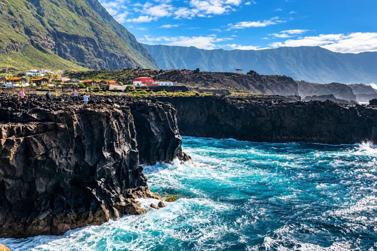 El Hierro collectible card artwork, black volcanic cliffs and turquoise water
