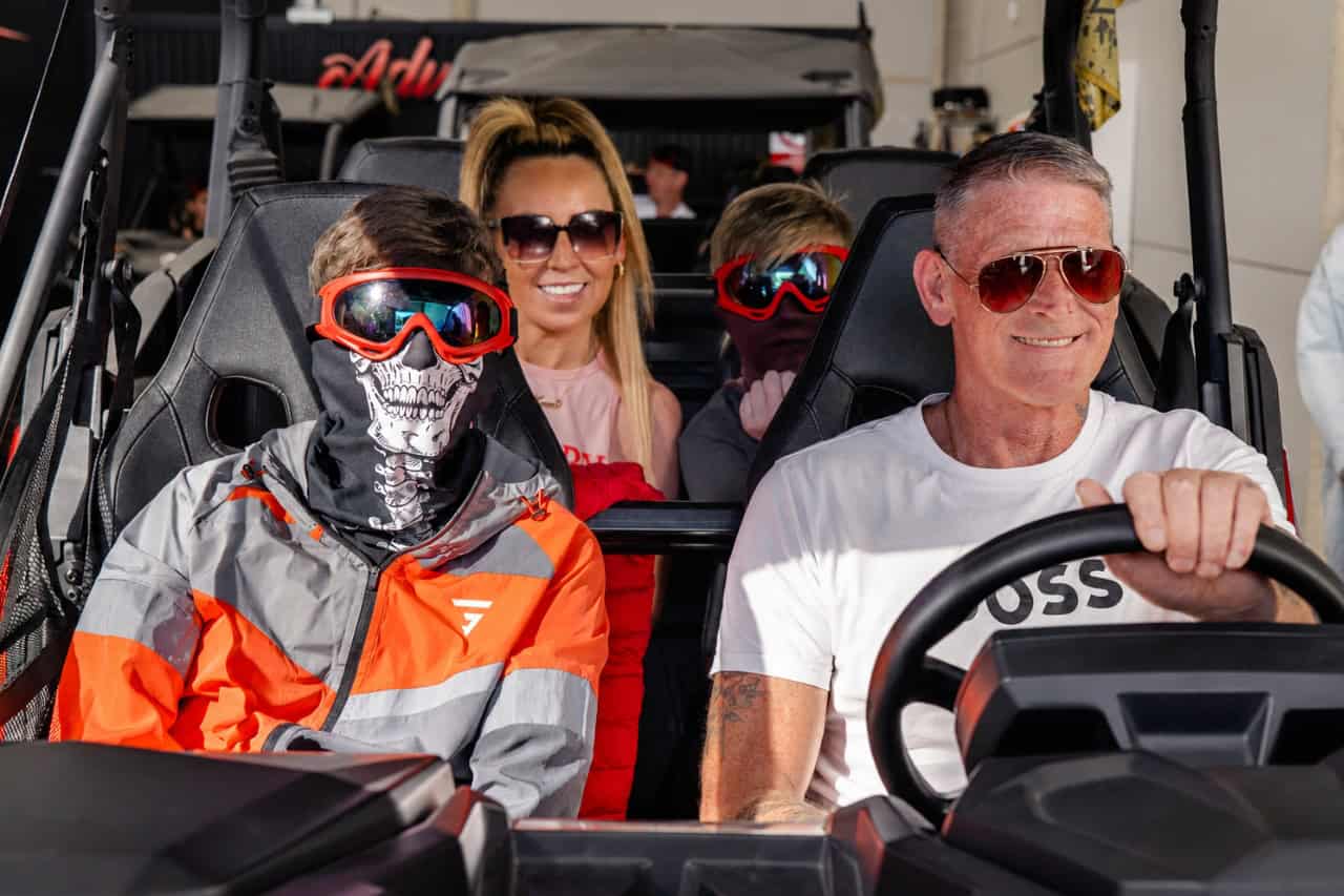Family seated together in a four seat buggy before the tour