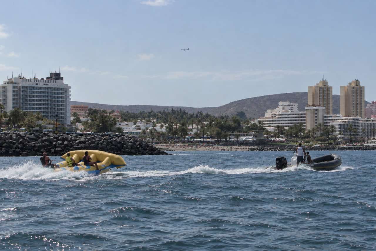 Yellow Flying Fish being towed across the sea near Playa de las Américas