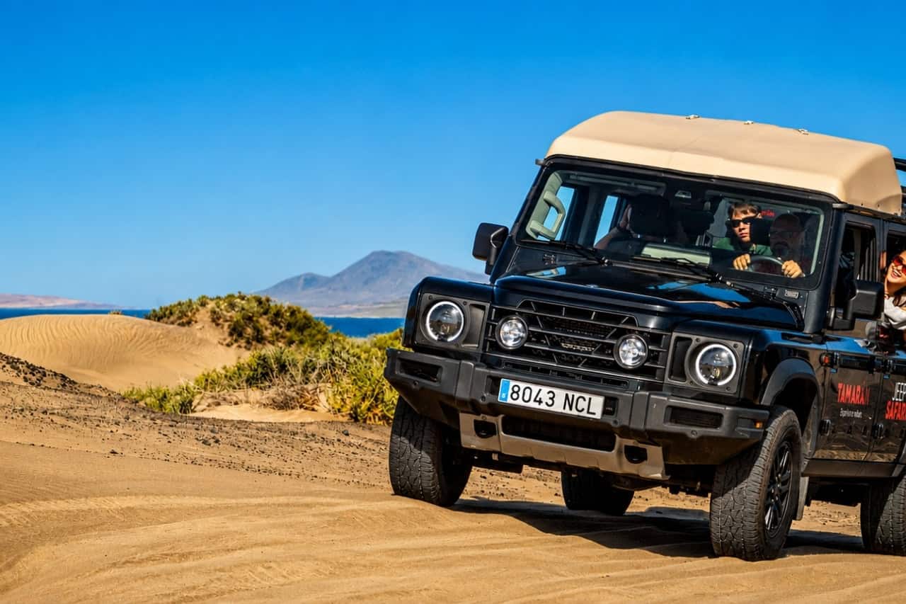 Jeep safari Lanzarote 4x4 driving a sandy off-road track with guests on board
