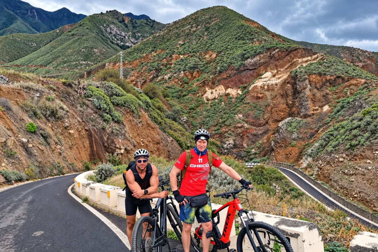 Cyclists with electric mountain bikes on a winding mountain road in Tenerife