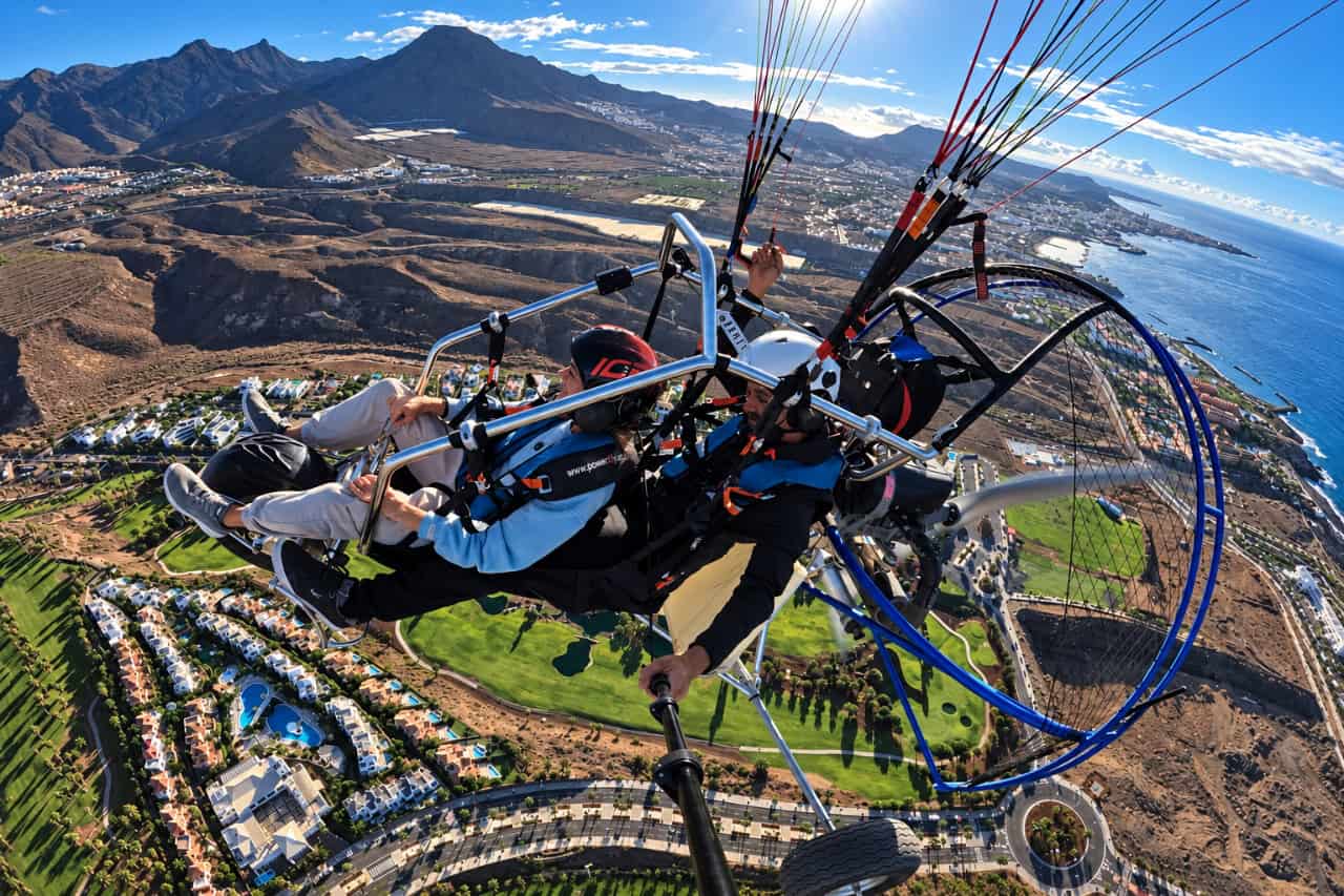 Tandem paratrike flight above southern Tenerife with sweeping views of the mountains, golf courses, coastal resorts and Atlantic Ocean.