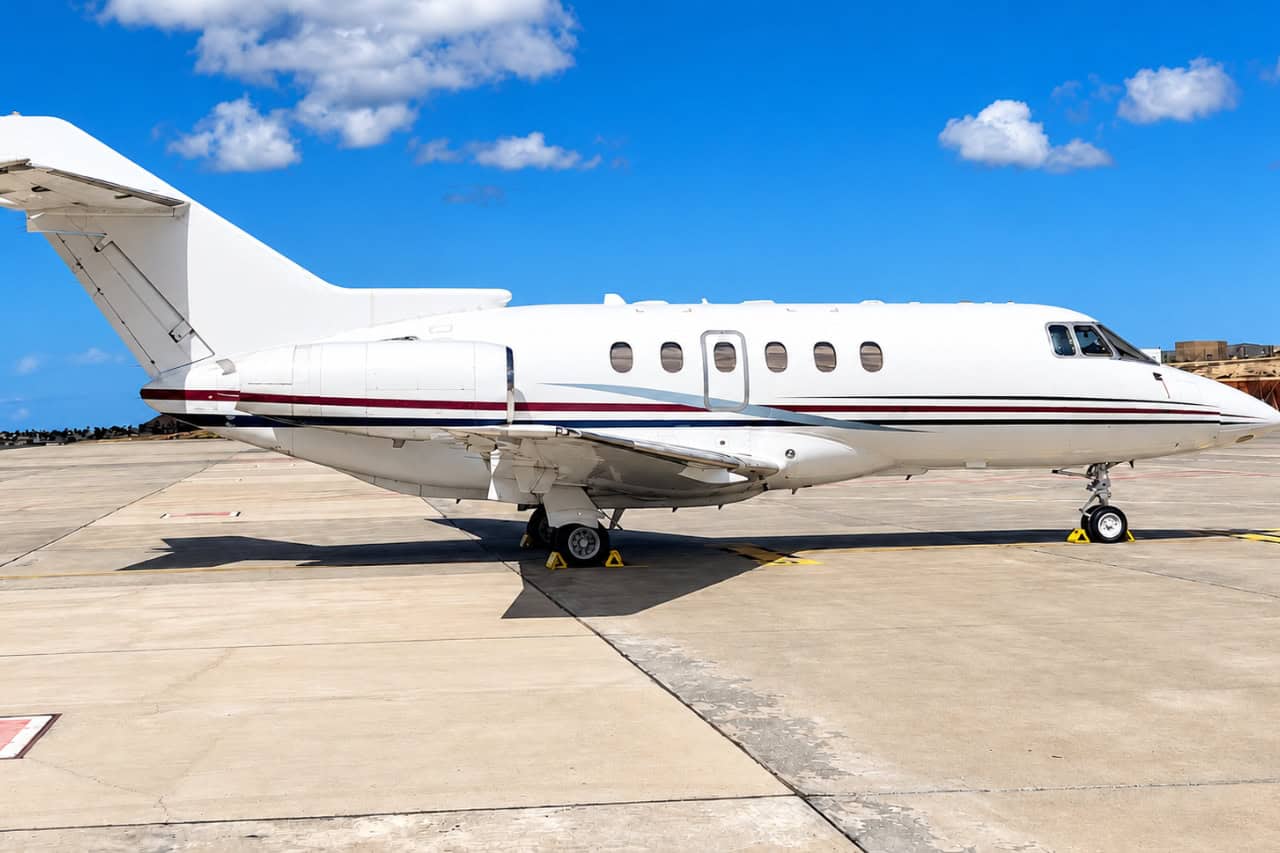 Private jet parked on the apron at Tenerife airport under a blue sky