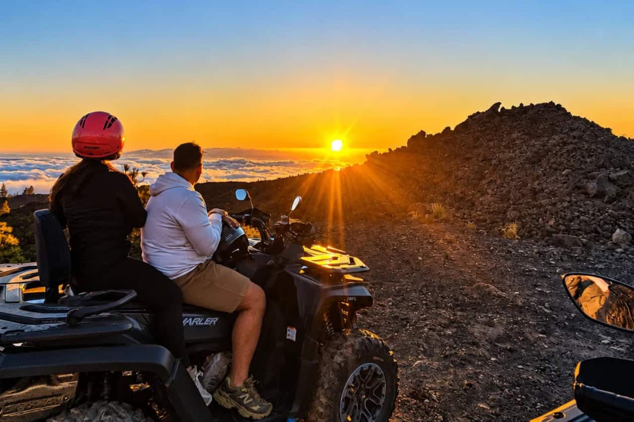 Couple on a quad above the clouds at sunset in Tenerife
