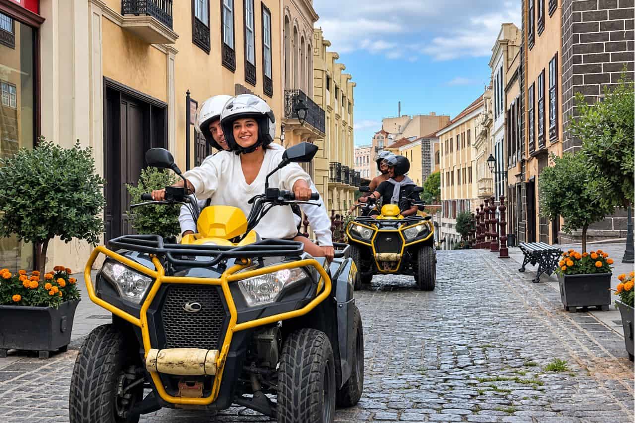 Guests riding yellow quad bikes through the historic streets of Puerto de la Cruz during a guided quad tour in northern Tenerife.