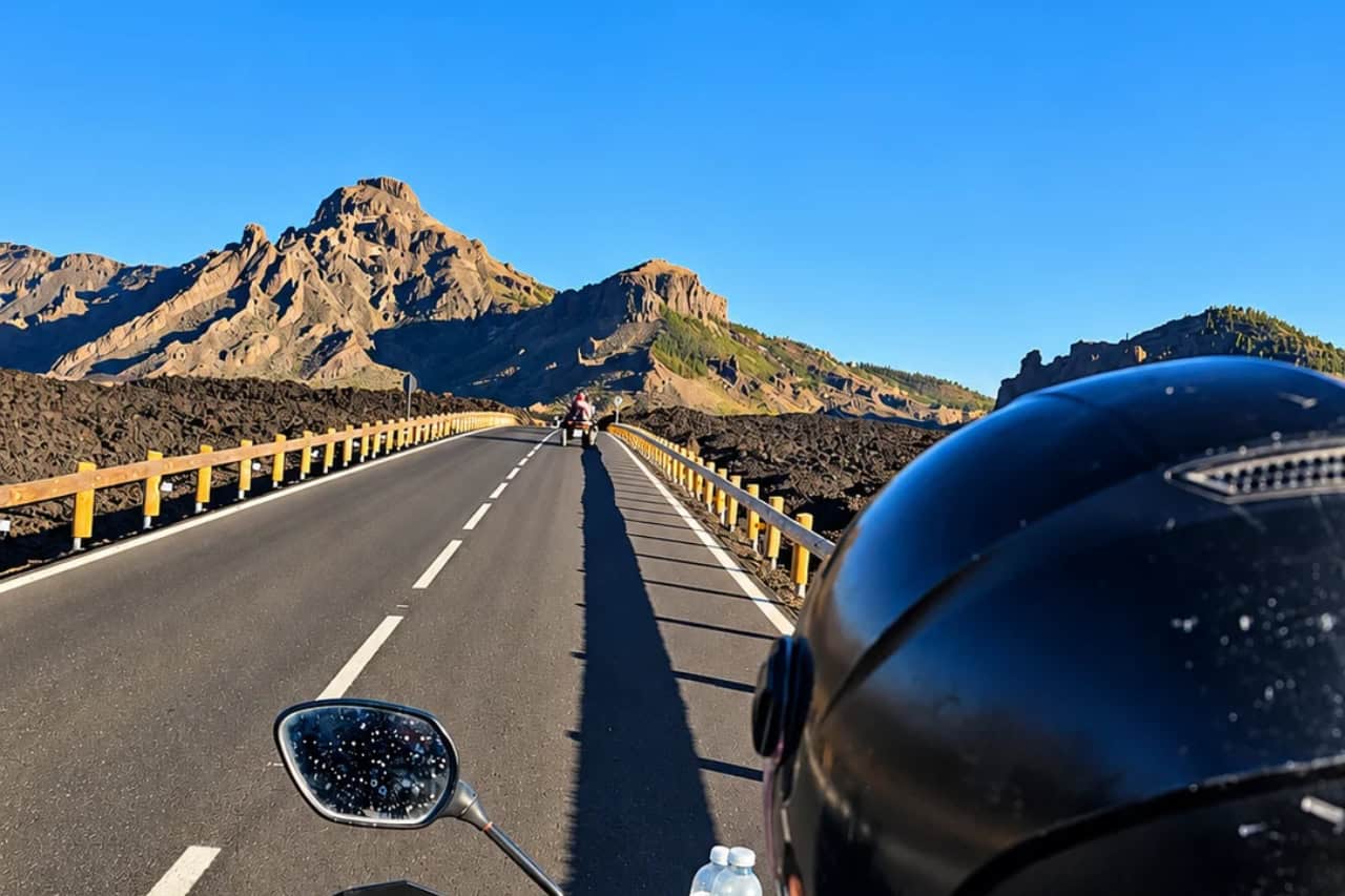 Rider on a scenic road through the volcanic landscape near Mount Teide